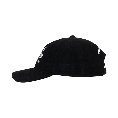 Side view of black hat showing white text on front and back