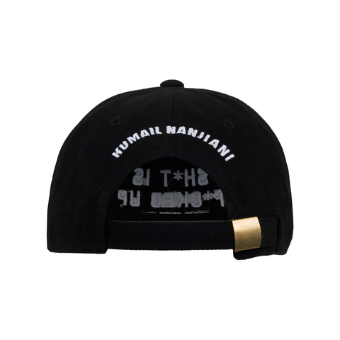 Rear view of black hat with adjustable strap with white text on back "KUMAIL NANJIANI"